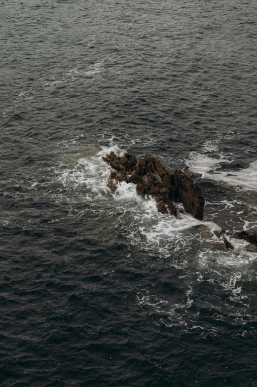 the rock is surrounded by ocean water