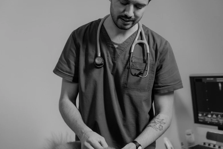 a man with a stethoscope is  up a cake