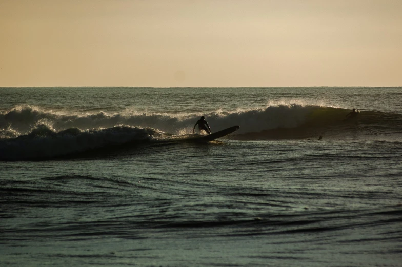 a man on a surfboard riding the wave