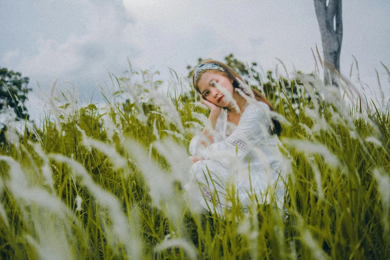 the lady is in a field with green grass