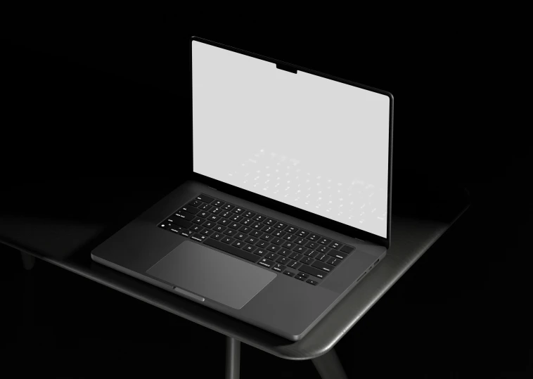 the black laptop has an open screen and is sitting on a small table