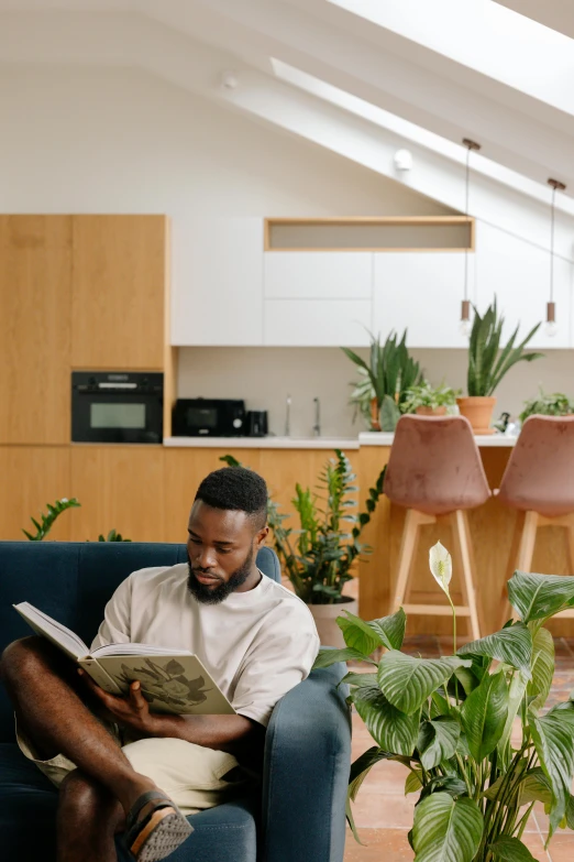 a man is sitting on a blue couch