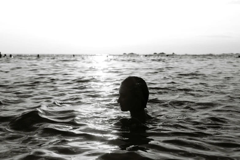 a person standing in the ocean holding onto a frisbee