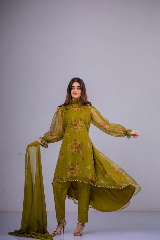 woman in green salwar with sheer - sleeved jacket and chiff