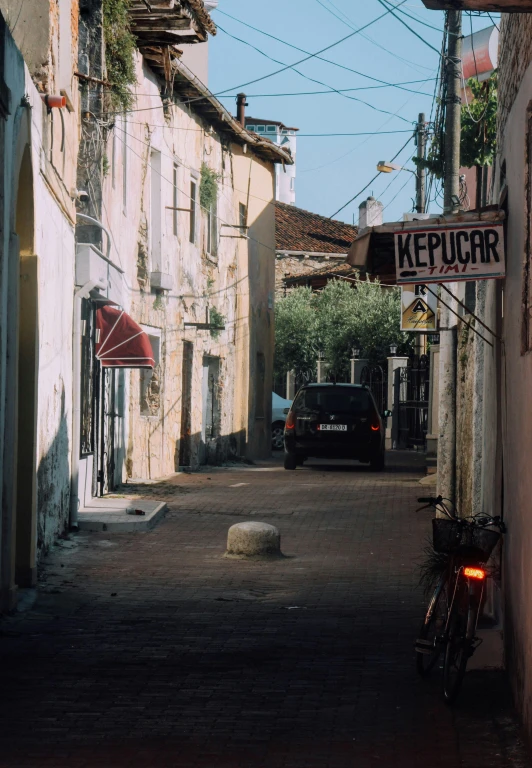 small town street with cars and bikes parked on both sides