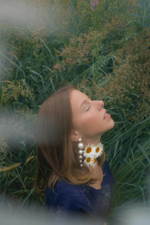 a woman laying in a field of wildflowers