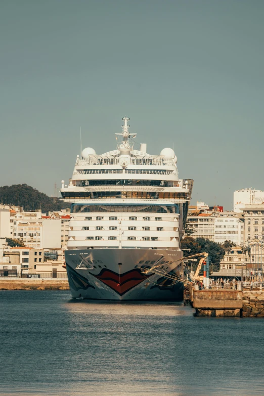 the ship is parked next to the dock at a port