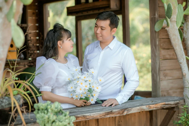 a man and woman standing outside next to each other