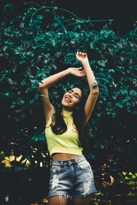 a  in a yellow top standing outside