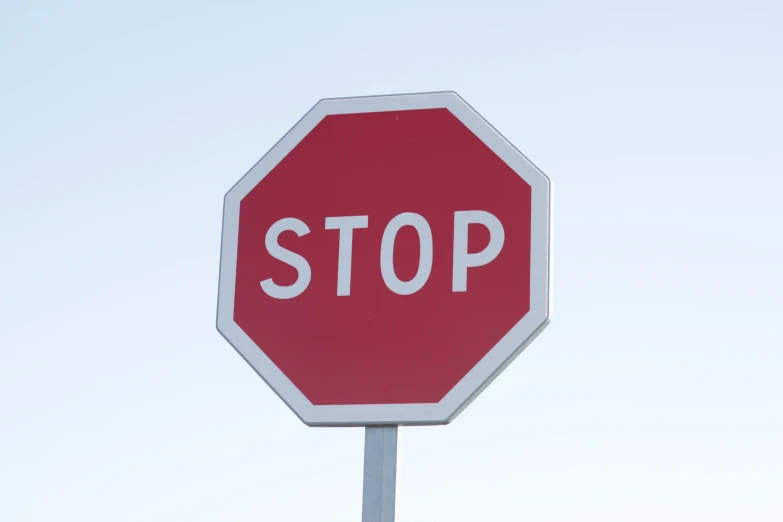 a stop sign that is standing in the grass