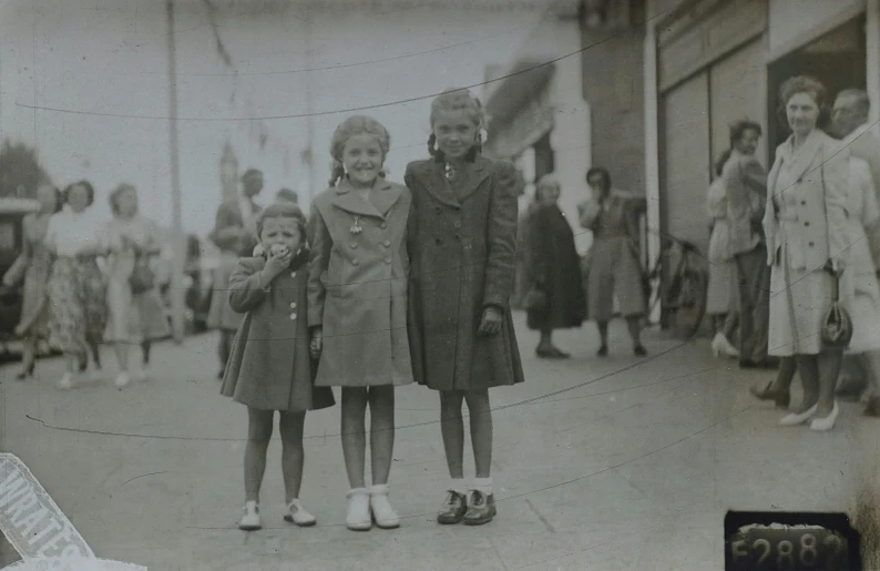 a black and white po of two girls standing in front of a building