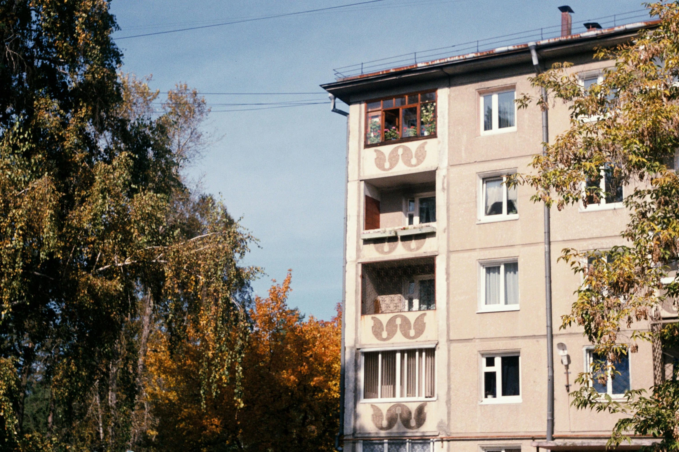 a tall building with windows on a street corner