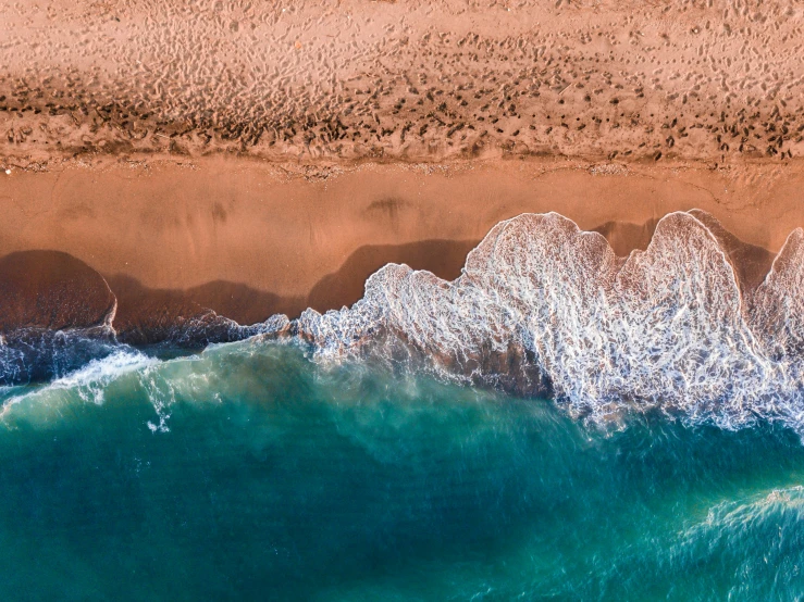 water covering the sand next to a beach