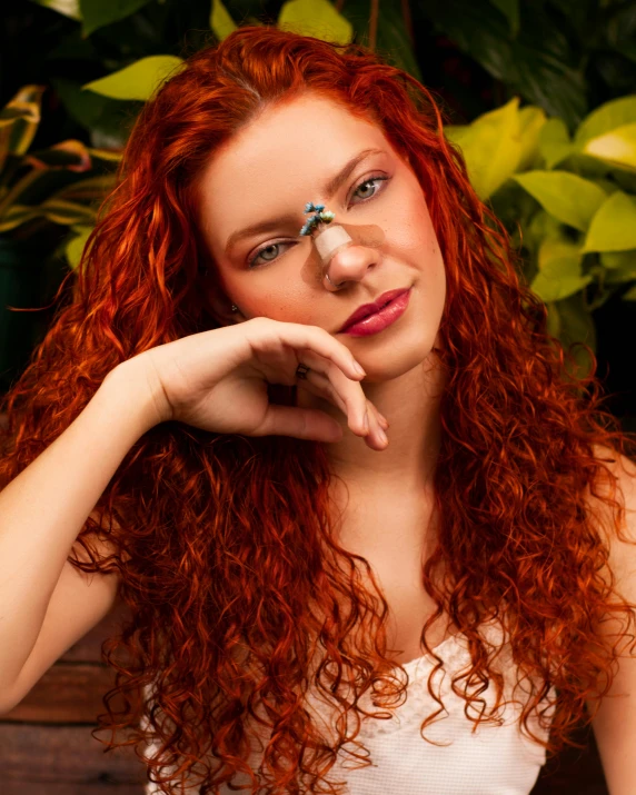 a close - up s of a red - haired woman with long, curly hair