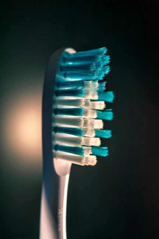 a closeup view of a tooth brush in the dark