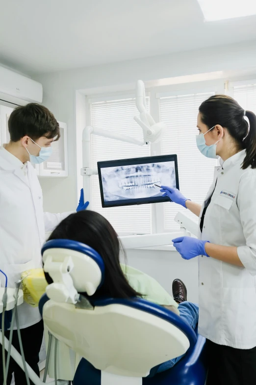 a dentist is showing soing to someone