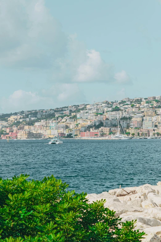 a boat sails through the water in front of a city