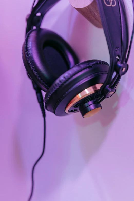 there are headphones attached to a purple wall