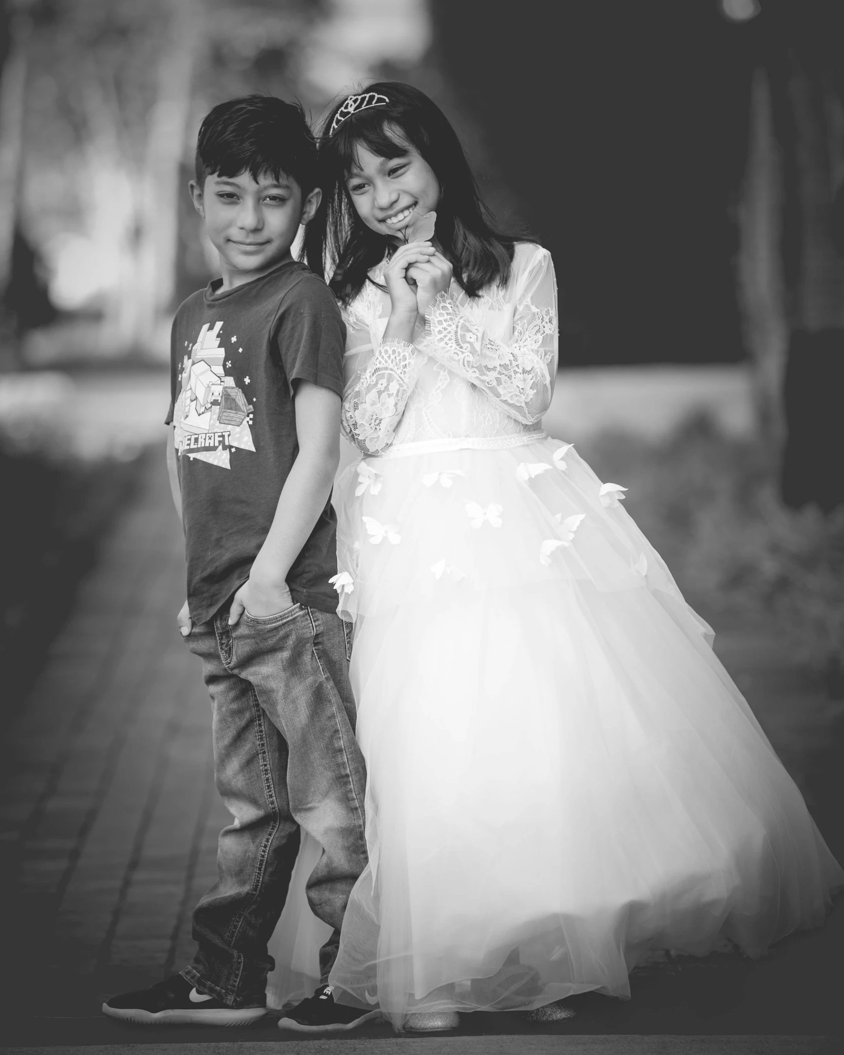 two children posing for a po in black and white