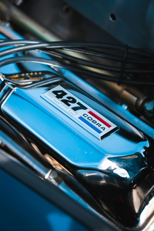 a picture of a blue car's hood, engine bay and the engine