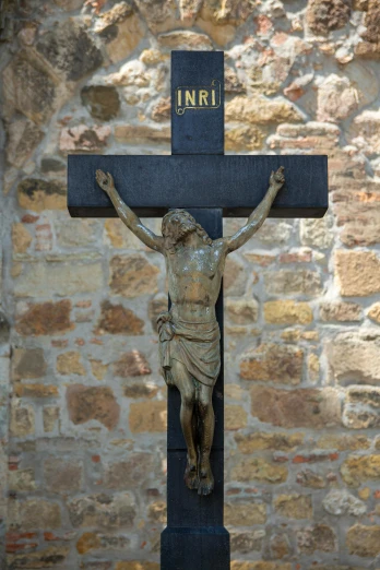 a bronze cross with the word i n r on it