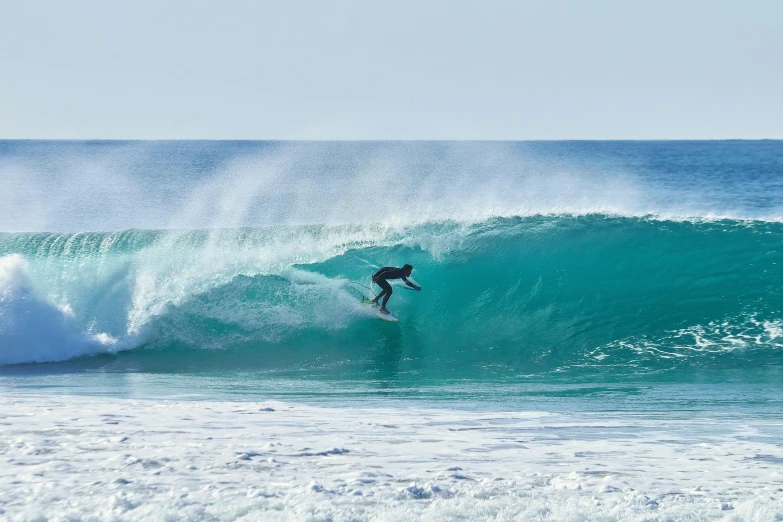 a surfer is riding the crest of a large wave