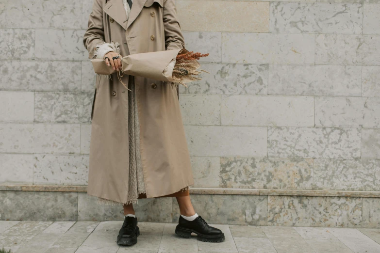 the woman is dressed nicely and standing near a building