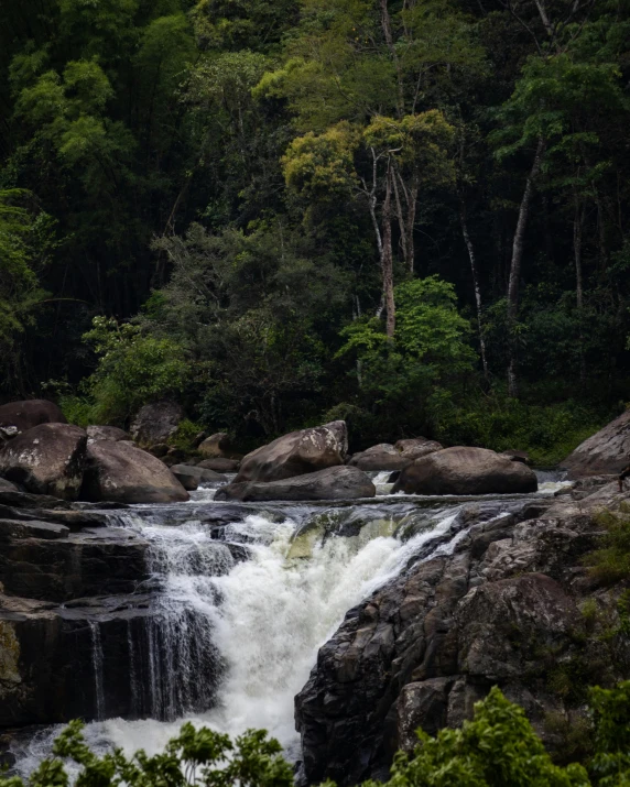 there is a river running by a bunch of rocks