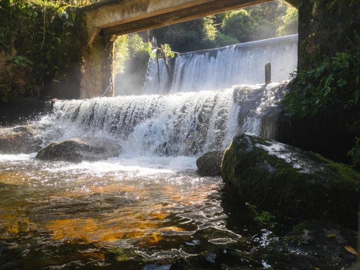 the water is tumbling over the small waterfall