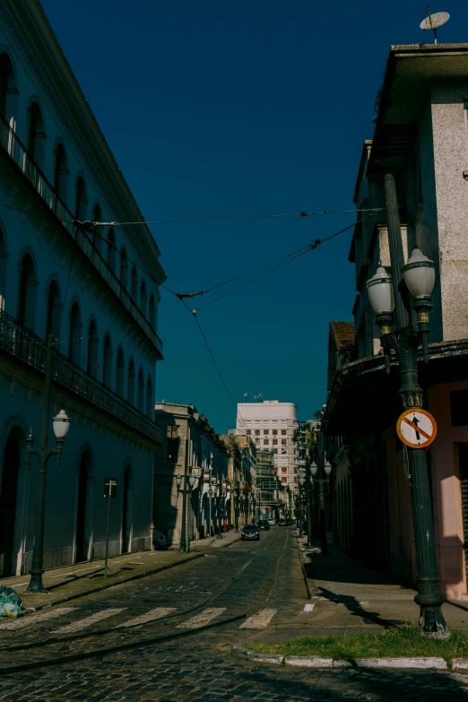 a cobblestone road in front of two buildings