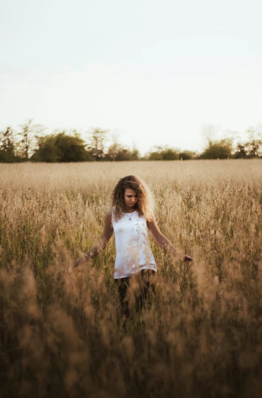 a person standing in a large field of grass