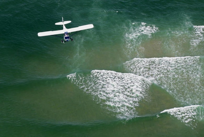 two water planes in green water near one another