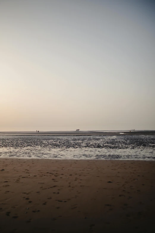 the person is riding a surf board on the beach