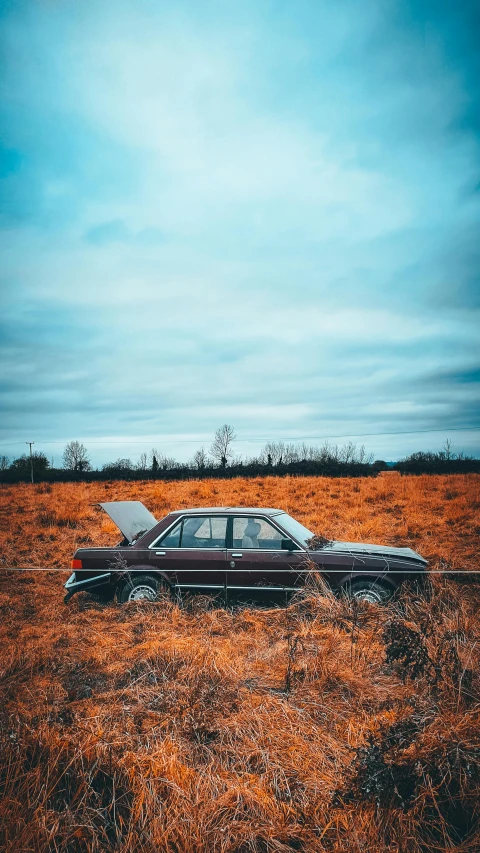 an old car parked in a field with no tires