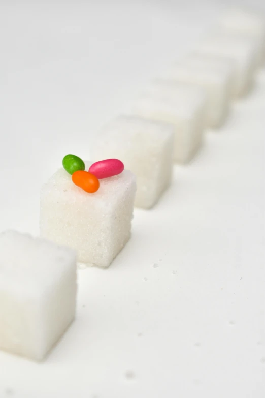 white marshmallows with one candy piece in center and one candy piece in middle
