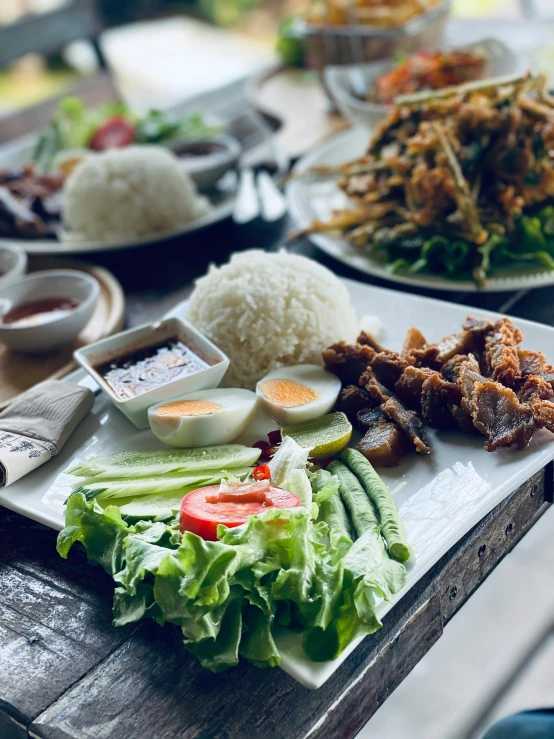 plates with asian food are on a table