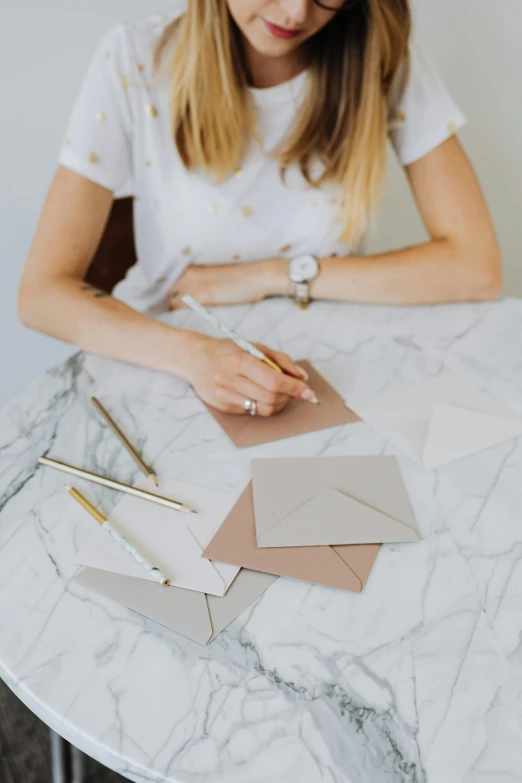 a young woman is working on some paper work