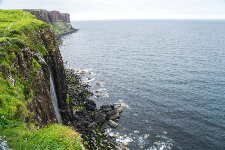 water flowing down the cliffs near the ocean