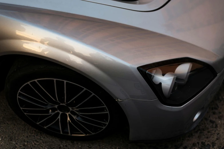 closeup view of side window and grill on the silver car