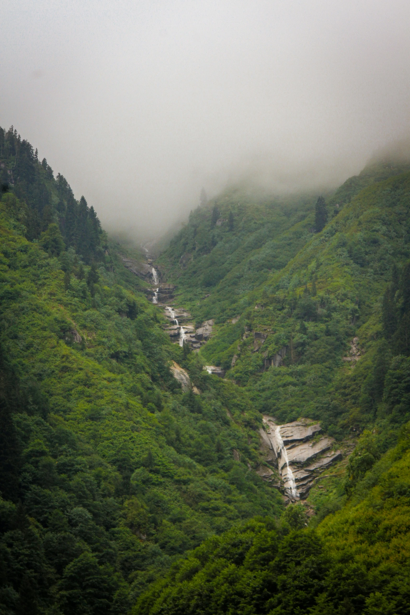 the valley with waterfall on both sides of it