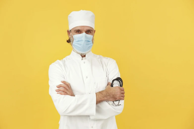 a man in white jacket and face mask