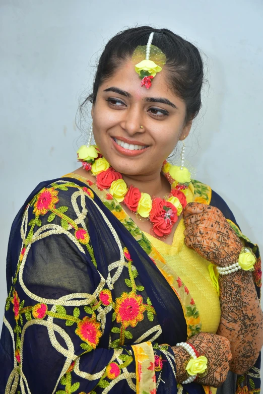 a beautiful indian woman holding a teddy bear