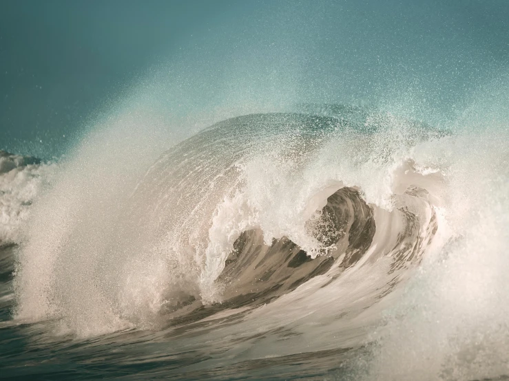 the ocean waves are crashing on the beach