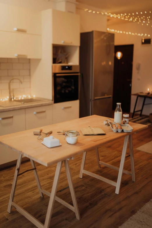 an empty wooden dining table in a kitchen