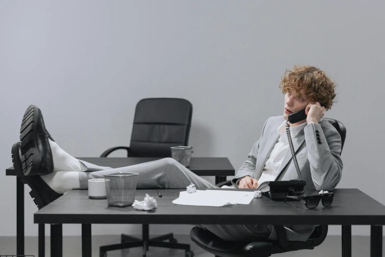 a person sitting at a table on the phone