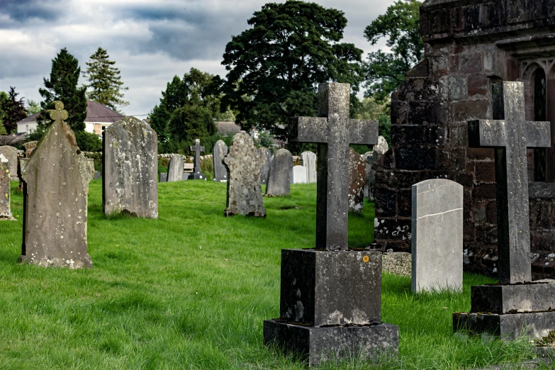 a cemetery full of headstones in a grassy area