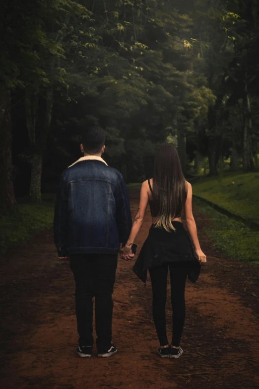 a couple walks down the road holding hands