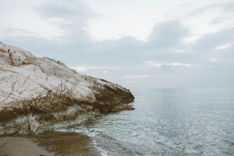 a rocky shore with water at the edge