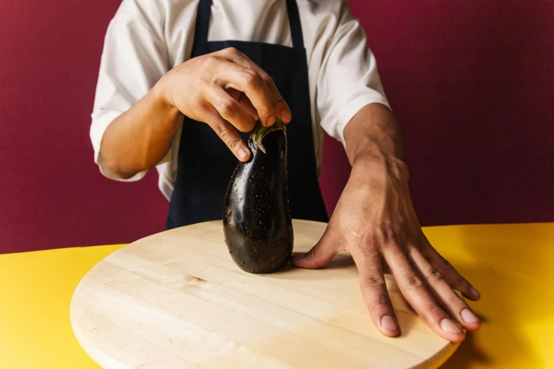 a person with apron and apron cleaning a bottle