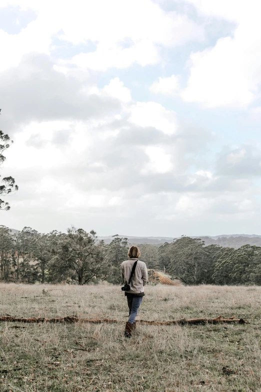 a person standing in a field watching soing